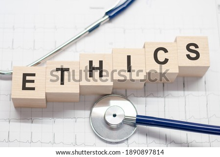 Ethics word written on wooden blocks and stethoscope on light background. Healthcare conceptual for hospital, clinic and medical busines.