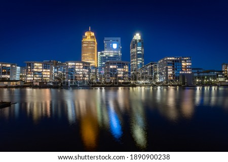 The Rembrandt tower is with 150meters the highest tower in the city located near the Amstel river - During blue hour with some colorful reflections on the water.  Amsterdam , Holland, The Netherlands
