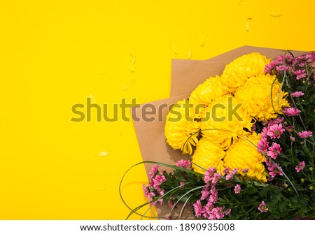 Lush and small chrysanthemums bouquet on bright yellow background with copy space, text place. Flower shop certificate. Holiday greeting card to Mother day, International Woman Day, Valentine Day.