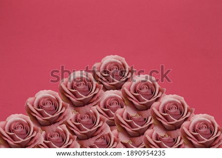 An arrangement of beautiful roses on a red background.