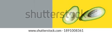 banner Illuminating and Ultimate Gray background. avocado on a yellow-gray background. Colors of the Year 2021.Banner Healthy Nutrition