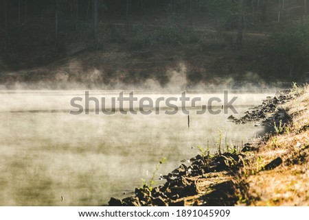 Morning mist Rising from the lake with golden sunshine Royalty-Free Stock Photo #1891045909