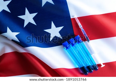 Injection usa. Medical syringe with needle for protection flu virus and coronavirus. Covid vaccine on american flag background. Concept fight against virus covid-19