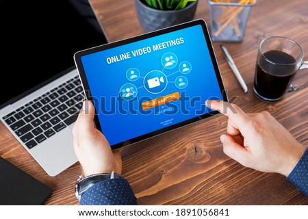 Man using online video meeting app on tablet computer