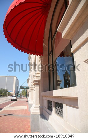 Red Parasol Shading Window with Reflection of Houston Clock Tower(Release Information: Editorial Use Only. Use of this image in advertising or for promotional purposes is prohibited.)