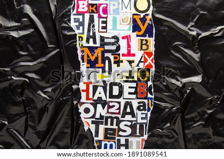 Torn and crumpled black glossy paper on collage from clippings with newspaper magazine letters and numbers. Ripped black paper on alphabet letters cutting from magazine background.