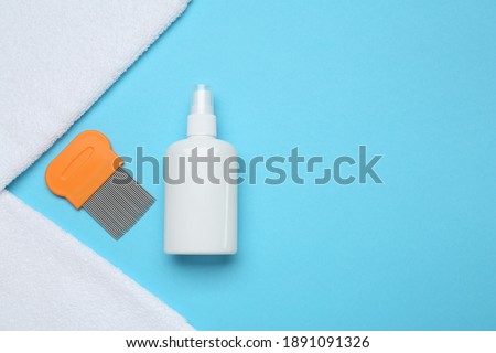 Comb, anti lice spray and towels on light blue background, flat lay. Space for text