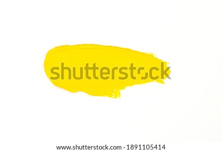 a smear of yellow paint isolated on a white background. yellow for 2021