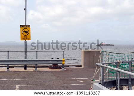 Sea View from Deserted Promenade with Warning Sign 'No Fishing'
