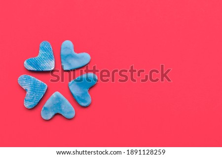 Blue hearts on red background.