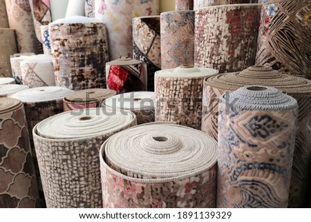 Various rugs in the carpet shop. Home decoration.