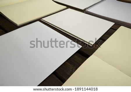 blank sheets, notebook, sketchbook, gray background 
