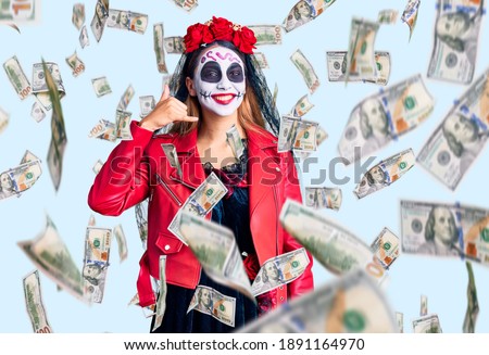 Woman wearing day of the dead costume over background smiling doing phone gesture with hand and fingers like talking on the telephone. communicating concepts.
