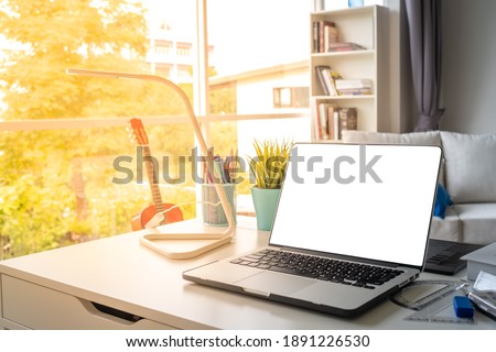 laptop or notebook with white display background on desk as work from home concept