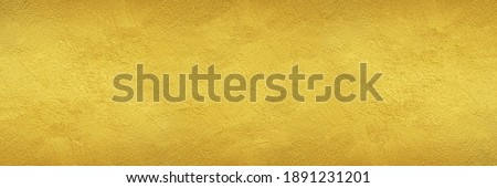 textured wall painted with gold color - wide banner or header format golden background Royalty-Free Stock Photo #1891231201