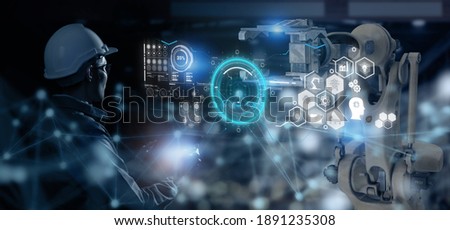 smart industry 4.0 futuristic technology concept, engineer use artificial intelligence combine  augmented mixed virtual reality display, digital twin with 5g to control robot arm in smart factory  Royalty-Free Stock Photo #1891235308