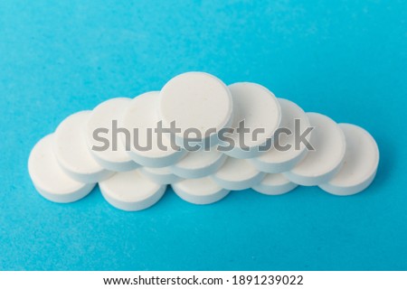 Heap of pills on blue background. pharmacetic concept: pills top view on blue background