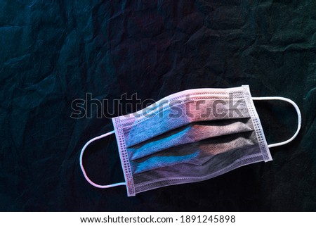 Medical mask or surgical earloop mask on Black paper background 