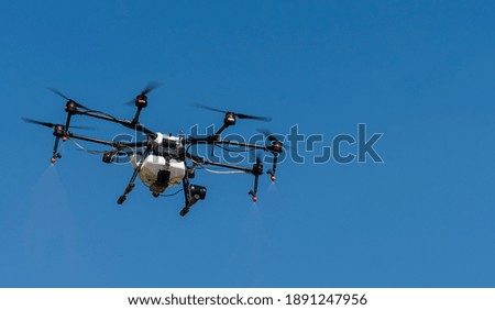Electric drone flying in blue sky , 