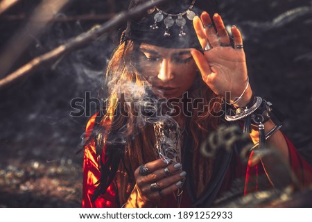 beautiful young woman with shamanic fire outdoors Royalty-Free Stock Photo #1891252933