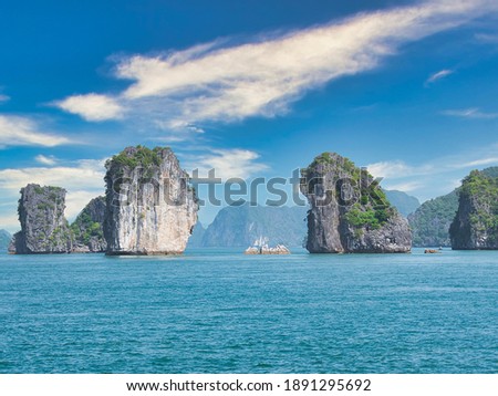 Islands of karst stone in Ha Long Bay (Vietnam) on a sunny day
