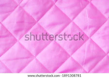 Pink color of cloth with diamond shape texture background 