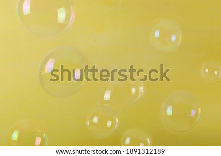 Lot of bubbles against bright yellow background.Happy summer time
