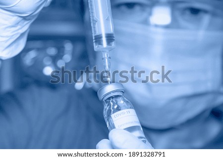 COVID-19 Coronavirus Vaccine - Female researcher testing potential vaccine at the lab.