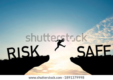 Risk management concept, Human jumping from risk cliff to safe cliff on cloud sky.