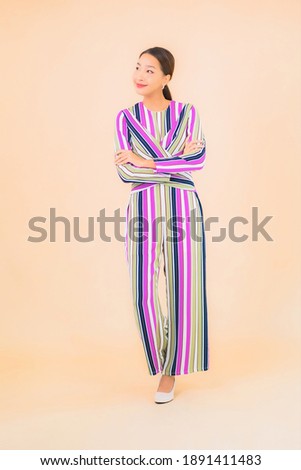 Portrait beautiful young asian woman smile relax in action on color background