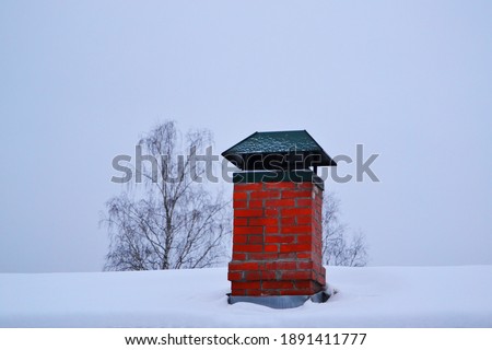 snow-covered old red brick chimney