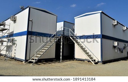 Beautiful Staircase in a Small House. Portable house and office cabins. Labor Camp. Porta cabin. small temporary houses