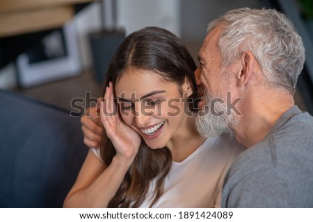 Happy together. A grey haired man saying compliments to his young spouse Royalty-Free Stock Photo #1891424089