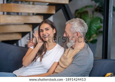 Generation gap. A smling woman hugging her handsome aged spouse Royalty-Free Stock Photo #1891424413