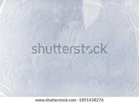 Wrinkled overlay. Wet paper creased texture. White scratched stained crushed transparent plastic polyethylene film. Weathered crumpled design background.