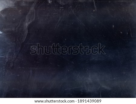 Noise overlay. Dust scratches effect. Smeared dirt grainy stains on dark blue aged grunge surface. Distressed texture layer for photo editing.