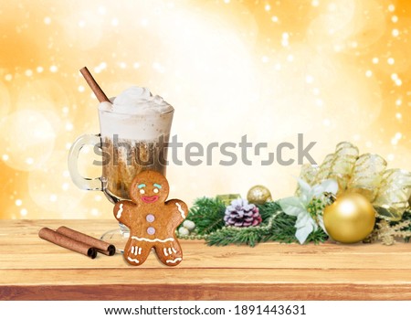 Christmas homemade gingerbread cookie and cup of hot chocolate on wooden table. Christmas food and drink concept