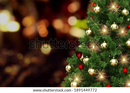 Festively Decorated Outdoor Christmas tree on blurred sparkling fairy background.