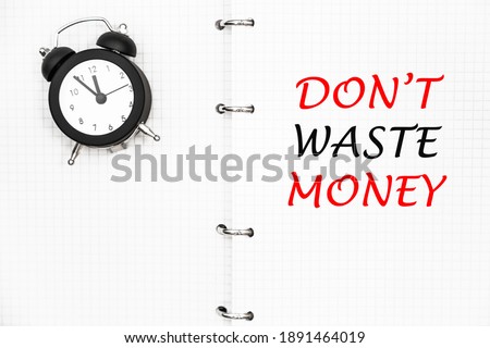 DON'T WASTE MONEY. THE TEXT IS WRITTEN IN A NOTEBOOK.