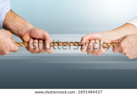 Business people pulling the rope in opposite directions Royalty-Free Stock Photo #1891484437
