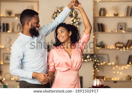 Happy Loving Family. Portrait of beautiful young african american couple in love dancing and looking at each other. Smiling black bearded man having fun with his pretty excited woman Royalty-Free Stock Photo #1891502917