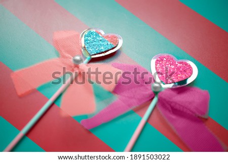 Two hearts on a pastel blue and red background