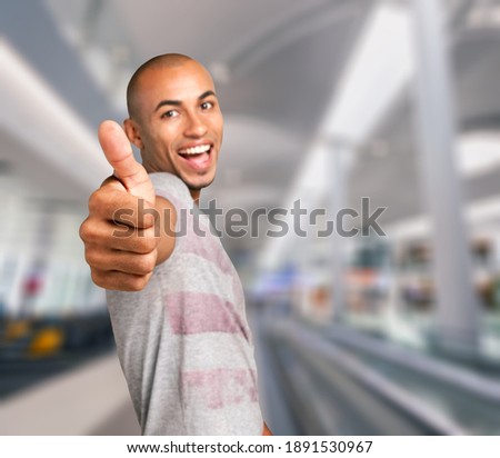 Attractive Young Man Showing Thumbs Up Sign,