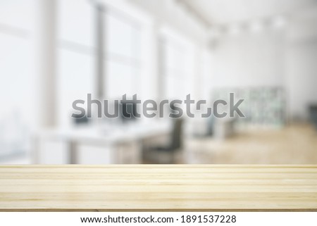 Blank tabletop made of wooden planks with light contemporary furnished office on background, mockup