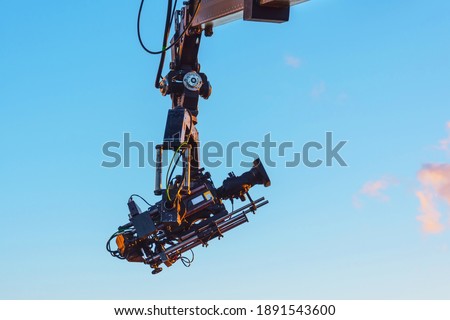 TV camera on a crane on at a public mass event