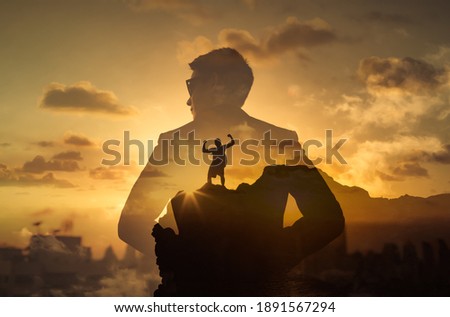 Successful strong brave man in the city feeling motivated conquering his physical and metal fears. Double exposure  Royalty-Free Stock Photo #1891567294