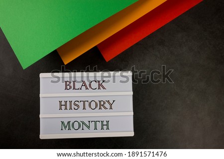 Black History Month. Red, yellow and green color paper on the black background. Flat lay. Copy space. 