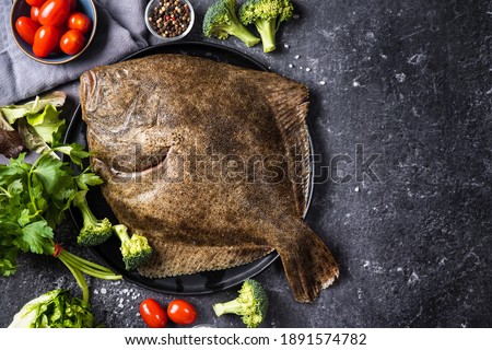 Raw halibut fish rich of omega fat on black background