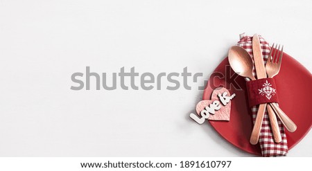 Composition with a plate and cutlery for a romantic dinner for Valentine's Day top view. Dating concept.