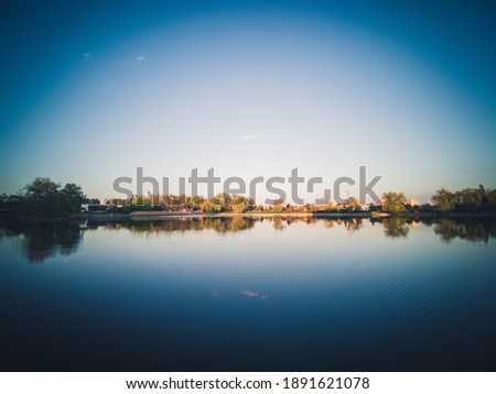 park in the city with a river, Sunset over city skyline